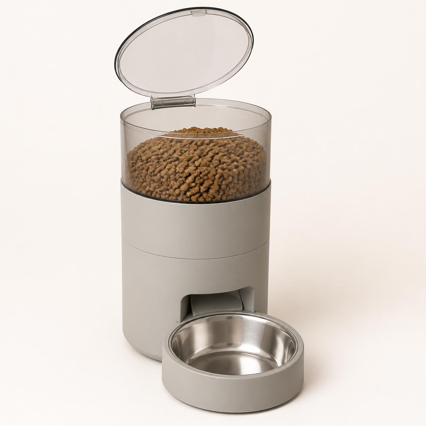 The automatic feeder in grey with the hopper lid open showing dry food inside