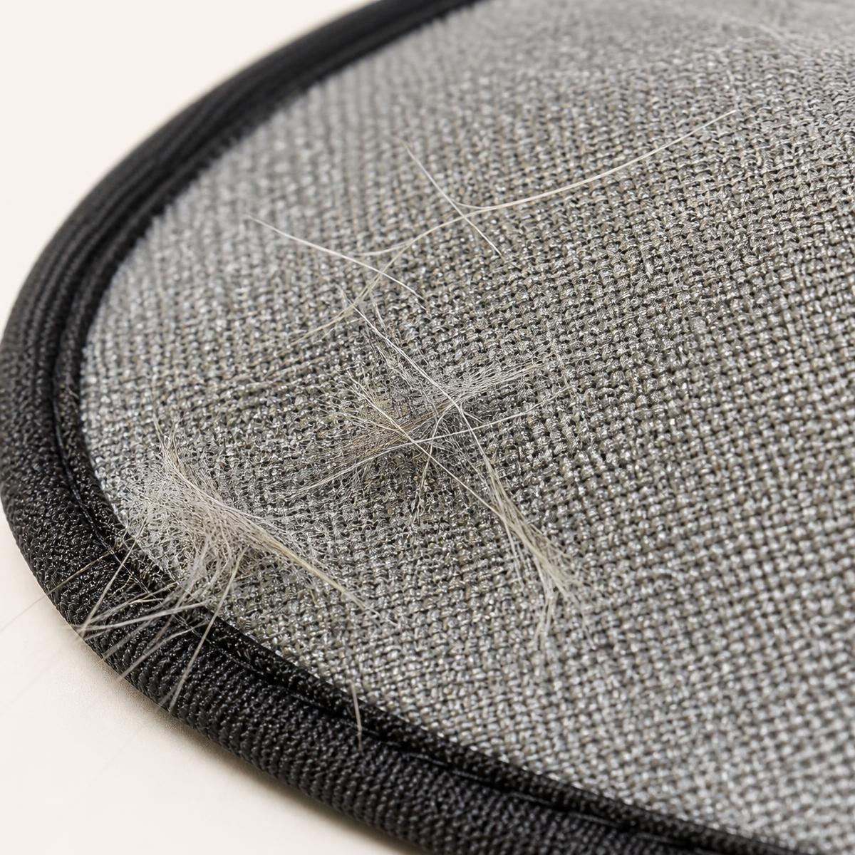 Close-up of the silver microfibre reverse side holding a gathered clump of pet hair